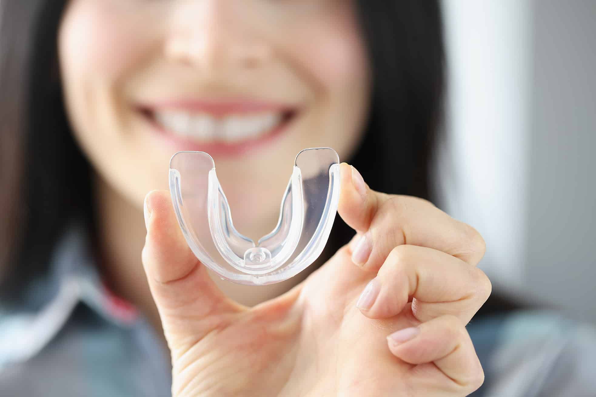 dental patient holding a sports mouthguard from stefan family dental